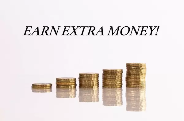 Stacks of coins with Earn extra money text