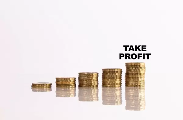 Stacks of coins with take profit text