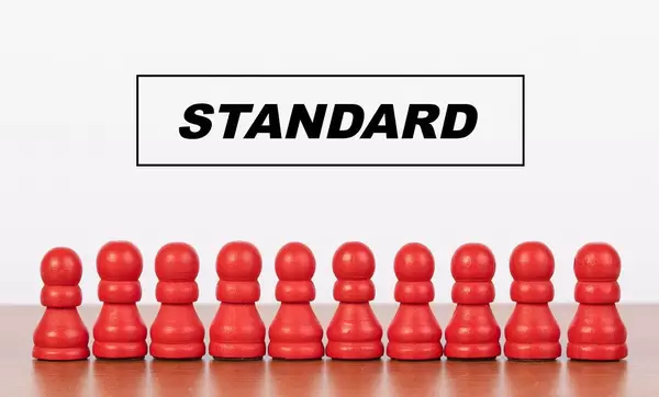 Standard concept with pawn figurines on table