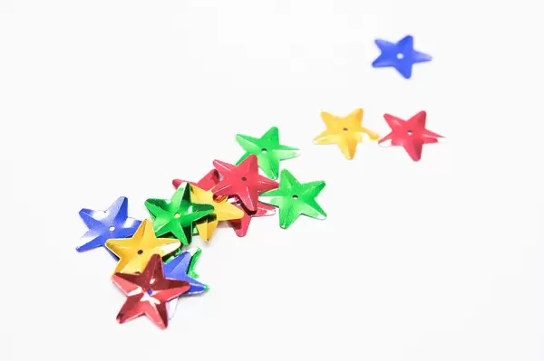 Star shaped sequins on a white surface