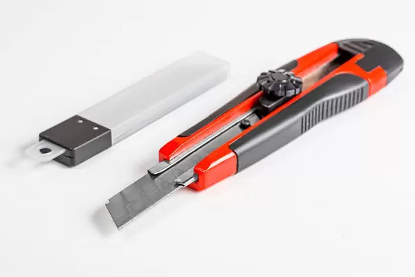 Stationery knife and packing of blades on a white background