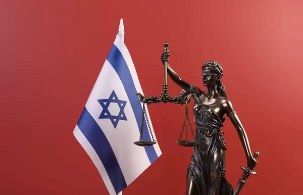 Statue of Lady Justice and flag of Israel on red background