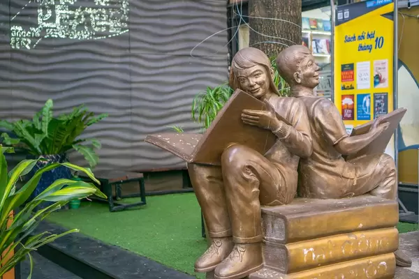 Statue of two People with open Books at Book Street in Saigon