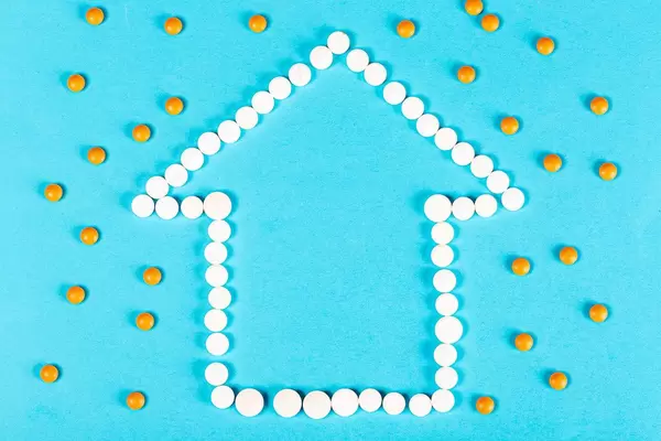 Stay at home concept. House made of pills
