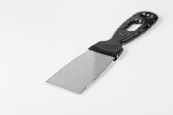 Steel trowel scraper with rubber handle on white background (Flip 2019)