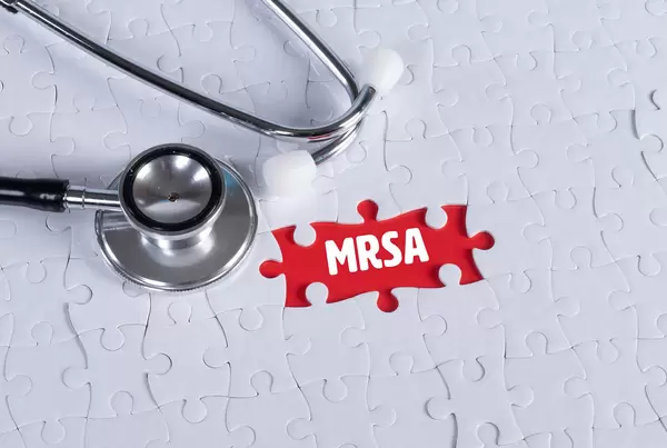 Stethoscope and missing puzzle with a MRSA text