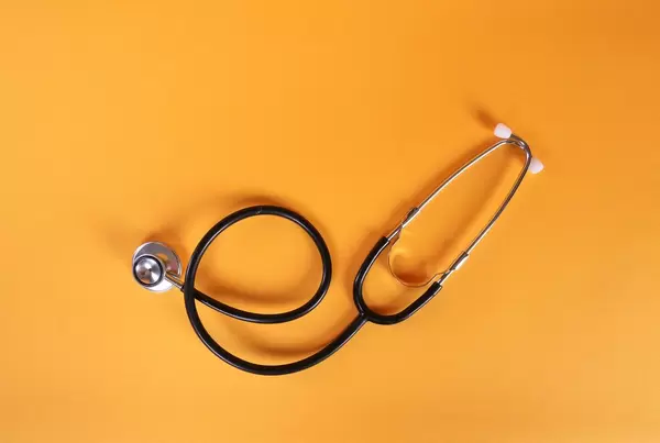 Stethoscope on orange background