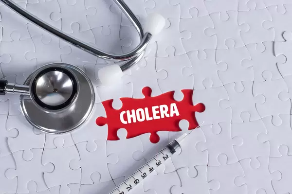 Stethoscope, syringe and missing puzzle with a Cholera text