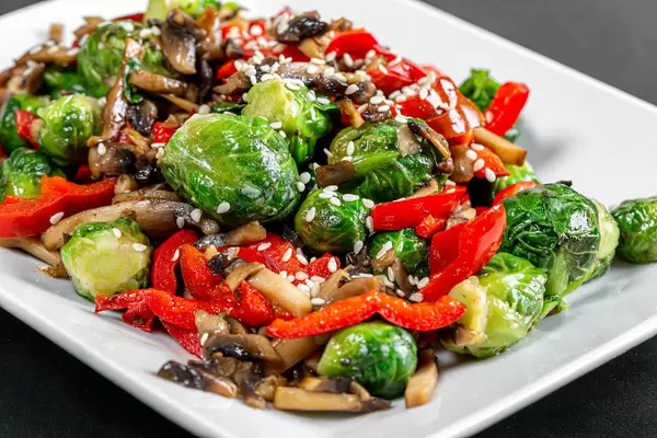 Stew with vegetables and mushrooms with sesame seeds closeup