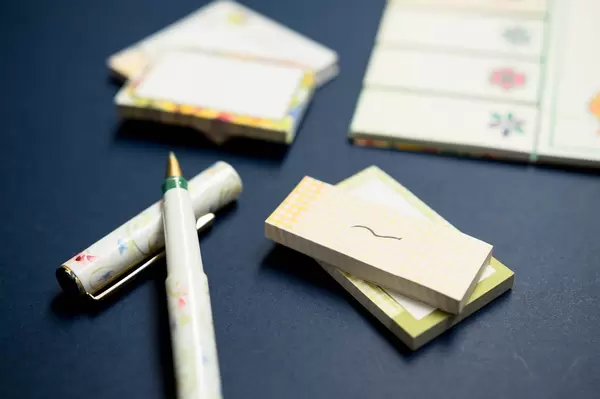 Sticky notes and pen on blue background