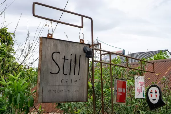 Still Cafe Entrance Board with other Brands on Wooden Boards in Da Lat, Vietnam