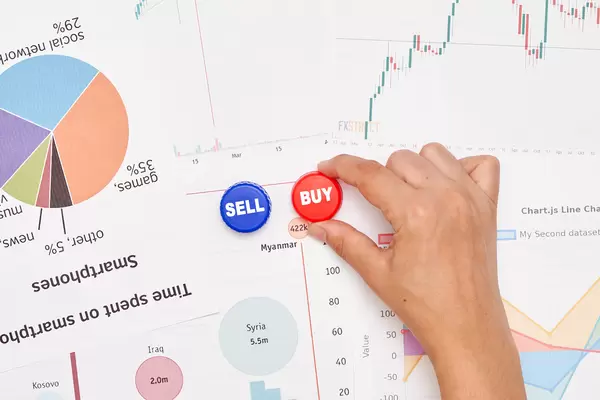 Stock market trader at work - buying and selling stocks