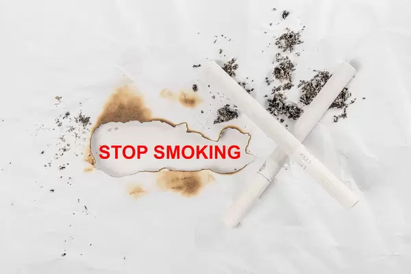 Stop smoking background with cigarettes and ash