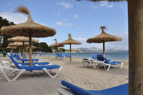 Strand mit Liegestühlen und Strohschirmen