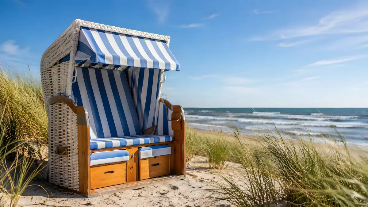 Strandkorb mit blau-weißen Streifen an der Nordseeküste
