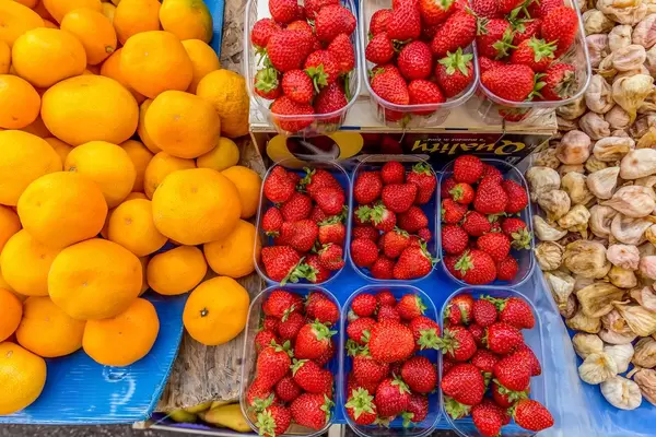 Strawberries, tangerines and dried figs on marketplace