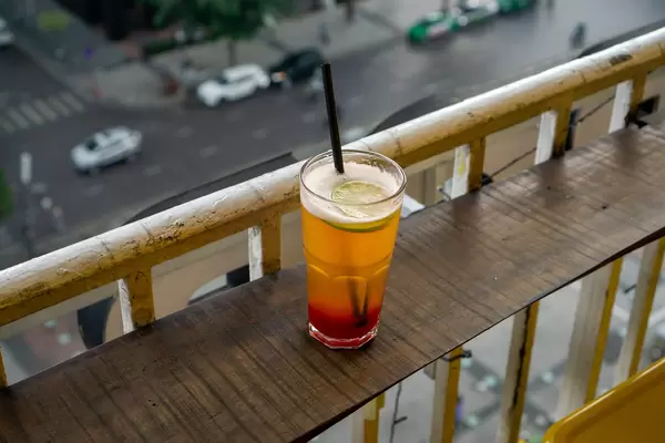 Strawberry Flavored Beer with Slice of Lime and Plastic Straw on a Balcony of The Cafe Apartment in Ho Chi Minh City, Vietnam