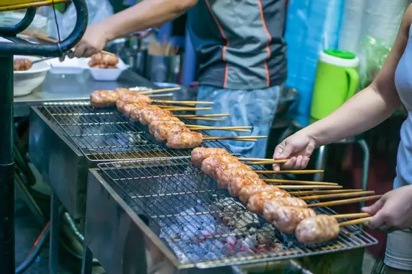 Street Food Barbecue Sticks at a Market in Saigon
