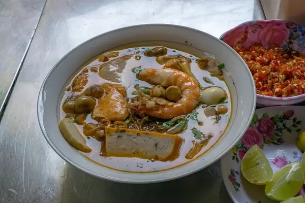 Street Food Noodle Soup with Seafood, Limes and Chili in Saigon