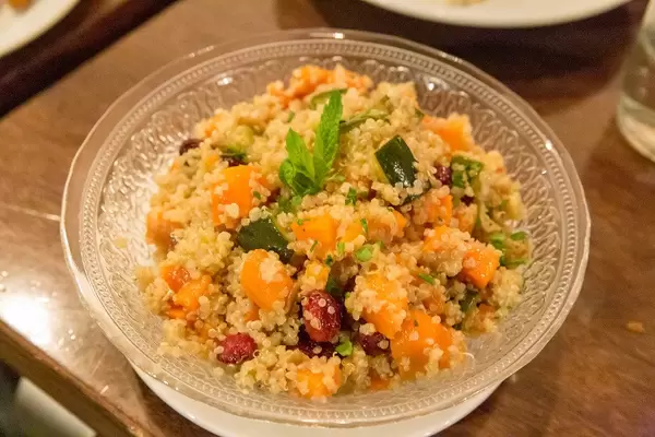 Streetfood by vegetarian "Hummus Restaurant" in Barcelona (Spain) with vegetable couscous, zucchini, chickpeas, sweet potatoes, carrots and pumpkin