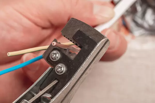 Stripping electrical wiring to install an outlet