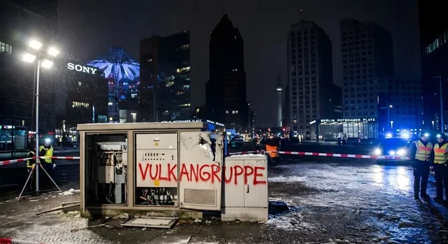 Stromkasten mit Graffiti in nächtlicher Berliner Stadtsilhouette