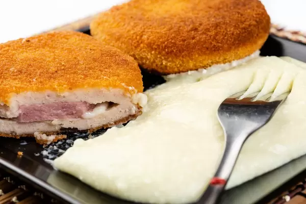 Stuffed and Fried Turkey Meat with Ham and Cheese on the plate (Flip 2019)