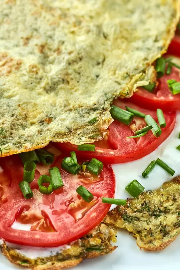 Stuffed omelet with tomatoes. Healthy diet food for breakfast