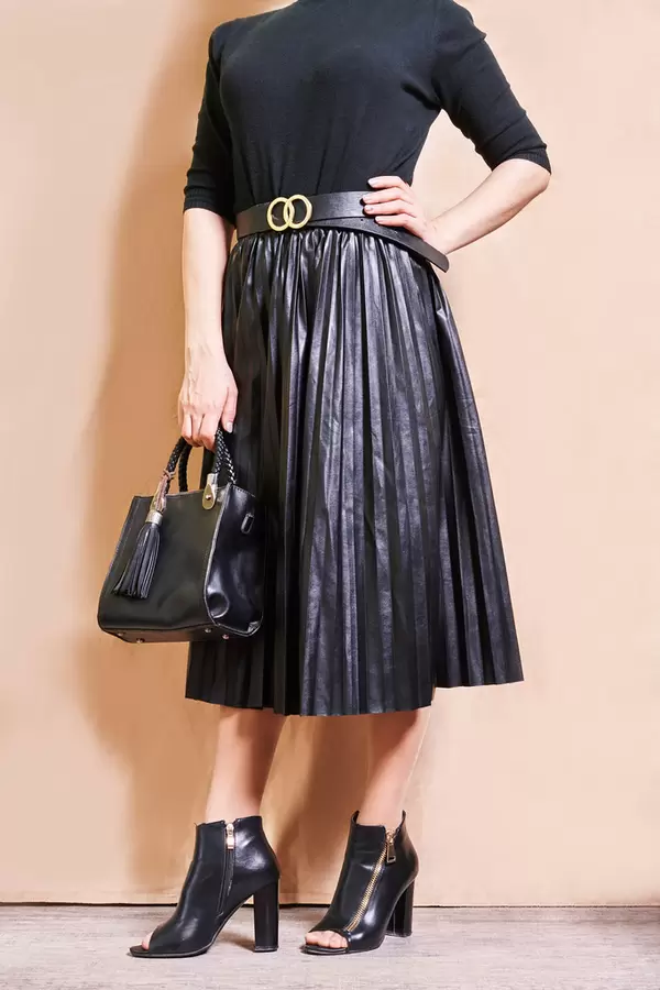 Stylish beautiful woman in a luxurious beautiful black pleated skirt