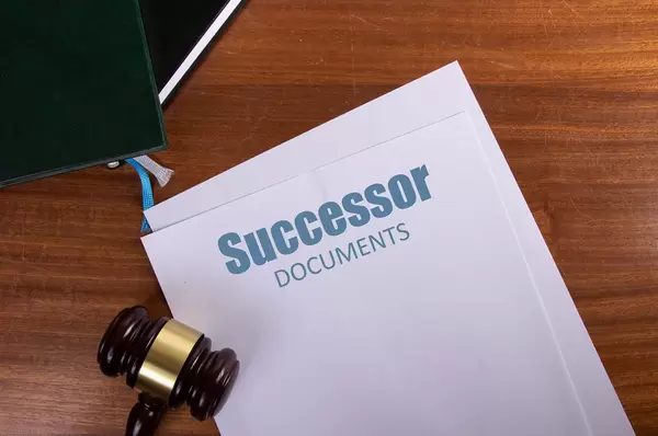 Successor Documents on table with judge gavel
