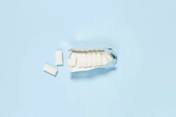 Sugarless chewing gums on bright blue background