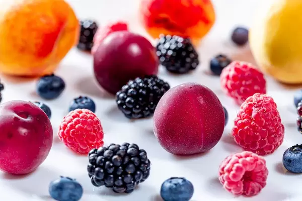 Summer background of fresh fruits and berries