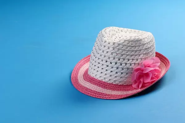 Summer beach hat on blue background
