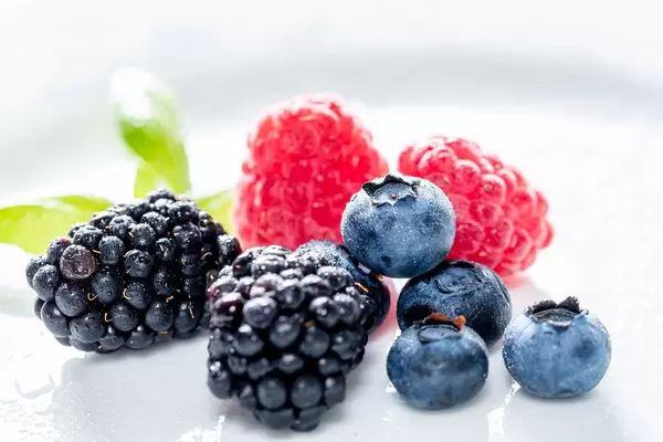 Summer berries of raspberry, blueberry and mulberry on white background (Flip 2019)