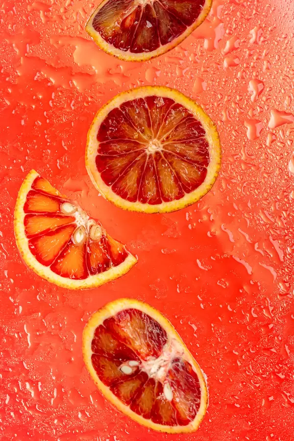 Summer red fruit background with ripe sicilian orange slices