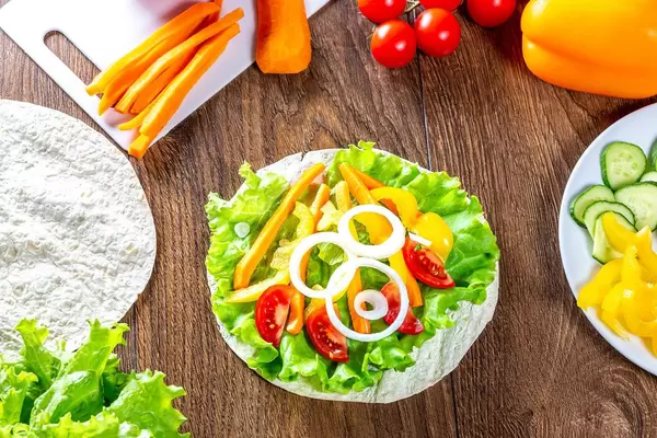 Summer ripe vegetables and pita on wooden background