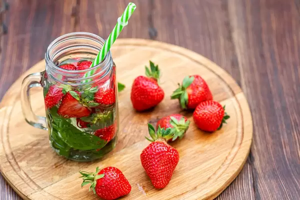 Summer strawberry drink with fresh mint leaves in a jar