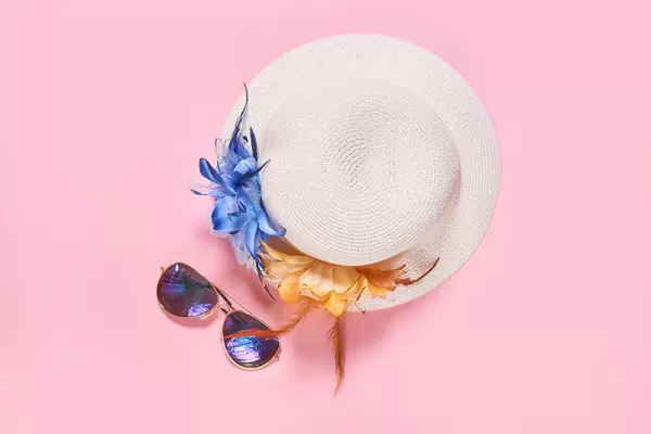 Summer vacation concept with travel accessories - female hat and sunglasses