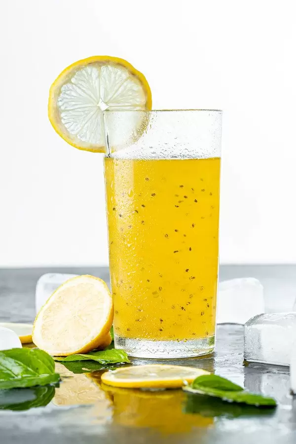 Summer yellow drink with lemon, mint leaves and ice
