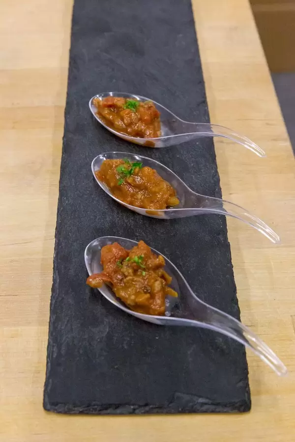 Sunflower Family - vegan organic sunflower bolognese tomato sauce on platic spoons as tasting samples