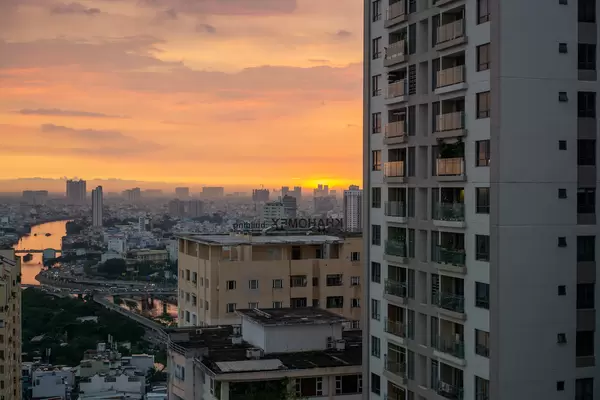 Sunset City View from an Apartment at Golden Hour with Sky Reflecting in River in Ho Chi Minh City, Vietnam