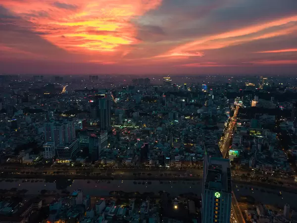 Sunset Drone Photo of Apartment Buildings in District 4 at Saigon River with View of Houses and Streets in the City Center of Ho Chi Minh City, Vietnam