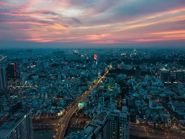 Sunset Drone Photo of Streets and Buildings with Lights from District 4 in Ho Chi Minh City, Vietnam