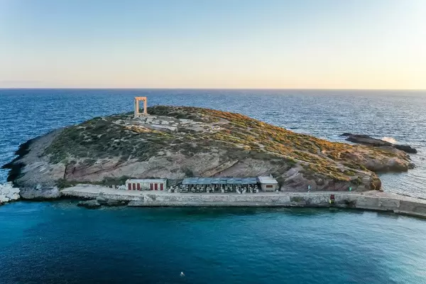 Sunset shot with a drone. The ruins of the Apollo temple, known as Portara. Main landmark of Naxos