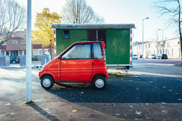 Supercompact red car parked on the street in Amsterdam