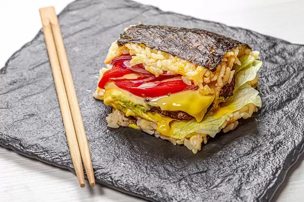 Sushi Burger on black background with chopsticks (Flip 2019)