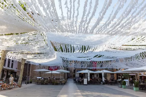 Suspended decoration made of white ribbons covering the whole main square of Pollença, Majorca