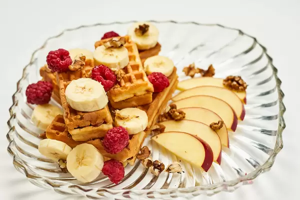 Sweet breakfast with fresh fruits and waffles