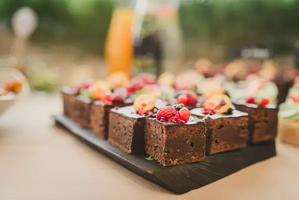 Sweet Brownie Squares With Various Berries On Top