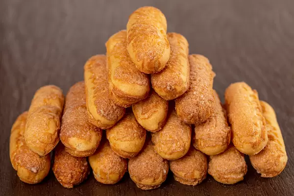 Sweet cookies in the form of sticks on a dark background